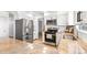 Bright kitchen with stainless steel appliances, granite countertops, and modern finishes at 7193 S Newport Way, Centennial, CO 80112