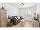 Bright living room with a comfortable couch, wood floors, and neutral-toned walls that create an inviting atmosphere at 7193 S Newport Way, Centennial, CO 80112