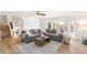 Sun-filled living room featuring a gray sectional sofa, decorative pillows, area rug, and large bay window at 7193 S Newport Way, Centennial, CO 80112