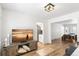 Bright living room with hardwood floors, entertainment center, and views of the dining room and kitchen at 7193 S Newport Way, Centennial, CO 80112