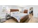 Cozy main bedroom featuring a wooden bed frame, matching dresser and a walk-in closet at 7193 S Newport Way, Centennial, CO 80112