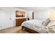Bright main bedroom featuring a queen bed, dresser, flat screen TV, and hardwood flooring at 7193 S Newport Way, Centennial, CO 80112