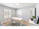 Comfortable home office featuring a work desk, hardwood floors, and white plantation shutters at 7193 S Newport Way, Centennial, CO 80112