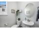 Clean bathroom with white vanity, oval mirror, and modern fixtures at 13267 E 108Th Ave, Commerce City, CO 80022