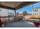 Covered deck with seating area, overlooking backyard with playset at 13267 E 108Th Ave, Commerce City, CO 80022