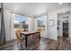 Bright dining room with farmhouse table, four chairs, and views to backyard at 13267 E 108Th Ave, Commerce City, CO 80022