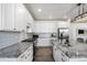 Bright kitchen with white cabinets, granite countertops, and a large work island at 13267 E 108Th Ave, Commerce City, CO 80022