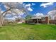 Spacious backyard featuring a lush lawn, mature trees, and a covered patio at 4555 E 121St Ct, Thornton, CO 80241
