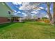 Expansive backyard with lush grass and a covered patio, perfect for relaxing at 4555 E 121St Ct, Thornton, CO 80241