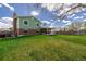 Large backyard with green lawn and covered patio, ideal for entertaining at 4555 E 121St Ct, Thornton, CO 80241