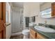 Bathroom featuring a walk-in shower, vanity and wood-trimmed accents at 4555 E 121St Ct, Thornton, CO 80241