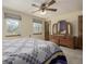 Bright bedroom with large windows, a patterned quilt, and wooden furniture at 4555 E 121St Ct, Thornton, CO 80241
