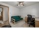 Bedroom area showcasing a comfortable futon, desk, and ceiling fan at 4555 E 121St Ct, Thornton, CO 80241
