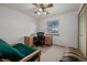 Bedroom area featuring a window, desk and a closet with folding doors at 4555 E 121St Ct, Thornton, CO 80241