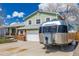 Charming two-story home featuring a large trailer on the driveway, brick accents and a spacious two-car garage at 4555 E 121St Ct, Thornton, CO 80241