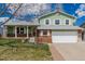 Charming two-story home featuring a manicured lawn, brick accents, and a spacious two-car garage at 4555 E 121St Ct, Thornton, CO 80241