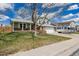 Charming two-story home featuring a manicured lawn, brick accents, and a trailer on the driveway at 4555 E 121St Ct, Thornton, CO 80241