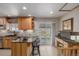 Bright eat-in kitchen with breakfast bar, sliding glass doors, and modern countertops at 4555 E 121St Ct, Thornton, CO 80241