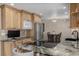 Modern kitchen boasts custom cabinets, granite countertops, and stainless steel appliances at 4555 E 121St Ct, Thornton, CO 80241