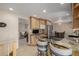 Modern kitchen with breakfast bar, stainless appliances, and seamless flow to living area at 4555 E 121St Ct, Thornton, CO 80241