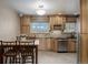 Eat-in kitchen features wooden cabinets, stainless steel appliances, and a dining table at 4555 E 121St Ct, Thornton, CO 80241