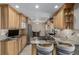 Spacious kitchen with granite countertops, custom cabinets, and eat-in dining area at 4555 E 121St Ct, Thornton, CO 80241