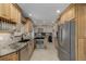 Well-lit kitchen featuring granite countertops, wooden cabinets, and stainless steel appliances at 4555 E 121St Ct, Thornton, CO 80241