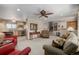 Open-concept living room with ceiling fan, carpeted floors, and staircase access at 4555 E 121St Ct, Thornton, CO 80241