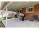 Covered patio area perfect for outdoor cooking with a grill and outdoor seating at 4555 E 121St Ct, Thornton, CO 80241
