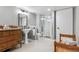 Classic bathroom with pedestal sink, shower, and tiled floor is bright and functional at 7250 Eastmoor Dr # 122, Denver, CO 80237