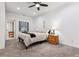 Neutral bedroom with ceiling fan, a cozy bed, natural light, and a side table at 7250 Eastmoor Dr # 122, Denver, CO 80237