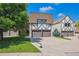 Charming home displaying two-car garage, stone and wood accents, and a well-manicured front yard at 7250 Eastmoor Dr # 122, Denver, CO 80237