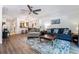 Bright living room boasts a modern ceiling fan, plush seating, and hardwood flooring at 7250 Eastmoor Dr # 122, Denver, CO 80237