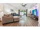 Open living area showcases hardwood floors, ample seating, and sliding glass doors to the backyard at 7250 Eastmoor Dr # 122, Denver, CO 80237
