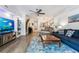 Cozy living room features a modern ceiling fan, comfortable seating, and hardwood flooring at 7250 Eastmoor Dr # 122, Denver, CO 80237