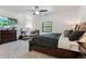 Main bedroom featuring a plush bed, carpeted floors, and a dedicated workspace at 7250 Eastmoor Dr # 122, Denver, CO 80237