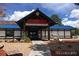 Exterior view of the restaurant with a stone entrance and well kept landscaping at 7250 Eastmoor Dr # 122, Denver, CO 80237
