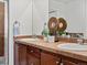 Bathroom featuring dual sinks with dark wood cabinetry and a decorative mirror at 9019 E Panorama Cir # D320, Englewood, CO 80112