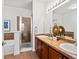 Well-appointed bathroom with double sinks, tiled accents, and a glass-enclosed shower at 9019 E Panorama Cir # D320, Englewood, CO 80112
