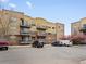 Apartment building with balconies, parking and brick facade creating curb appeal at 9019 E Panorama Cir # D320, Englewood, CO 80112