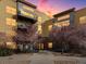 Modern building with balconies and well-maintained landscaping at twilight provides a sense of tranquility at 9019 E Panorama Cir # D320, Englewood, CO 80112