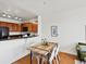 Open-concept dining area and kitchen with modern table, chairs, and sleek countertops at 9019 E Panorama Cir # D320, Englewood, CO 80112