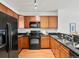 Well-equipped kitchen features ample wood cabinets and sleek black appliances for a modern touch at 9019 E Panorama Cir # D320, Englewood, CO 80112