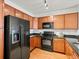 Well-equipped kitchen features ample wood cabinets and sleek black appliances for a modern touch at 9019 E Panorama Cir # D320, Englewood, CO 80112