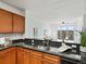 Open-concept kitchen features granite countertops, stainless steel sink, and opens to the living area at 9019 E Panorama Cir # D320, Englewood, CO 80112