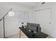 Functional home office setup with a desk, monitor, and a sleek lamp for task lighting at 9019 E Panorama Cir # D320, Englewood, CO 80112