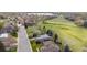 Wide aerial view of a neighborhood with homes, streets, and green spaces, with lake in distance at 2330 Sandpiper Dr, Lafayette, CO 80026