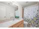 Bathroom with patterned shower curtain and wood vanity at 2330 Sandpiper Dr, Lafayette, CO 80026