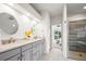 Modern bathroom features a double vanity with stylish fixtures and a glass-enclosed shower at 2330 Sandpiper Dr, Lafayette, CO 80026