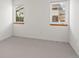Empty bedroom with two windows, carpet, and neutral colored walls at 2330 Sandpiper Dr, Lafayette, CO 80026